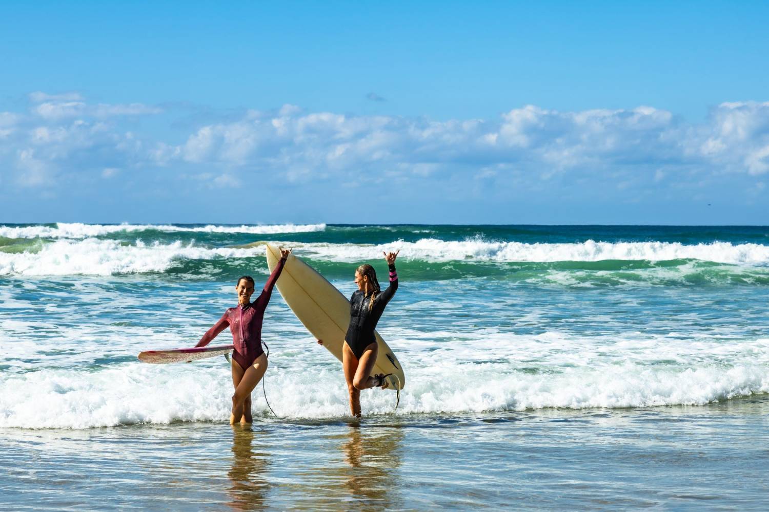 Surfers walking down to the water on an Australian surf coast
