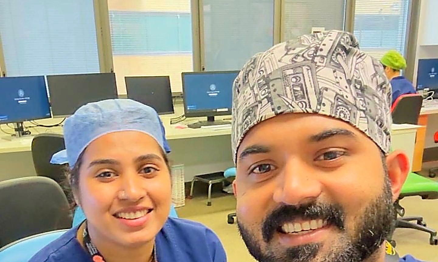 Amal and Sandra, both anaesthetic technicians, in theatre scrubs and caps at work in Wellington